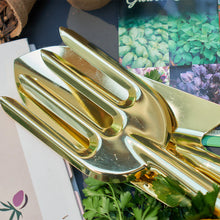 Load image into Gallery viewer, A close up picture of gold gardening tools in an outdoor setting.