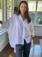 Load image into Gallery viewer, Woman wearing a white shirt and dark pants indoors