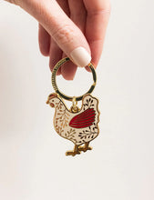 Load image into Gallery viewer, Hand holding a keychain shaped like a rooster with a red comb on a white background