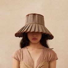 Load image into Gallery viewer, Woman wearing a woven hat against a beige background