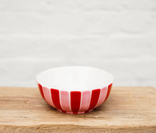 Load image into Gallery viewer, Red and white striped ceramic bowl on a wooden surface with a light gray background