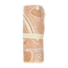 Load image into Gallery viewer, Picture of tan floral sand-free towel rolled up on a white background.
