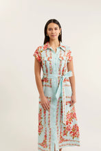 Load image into Gallery viewer, Woman wearing a floral dress with a light blue background