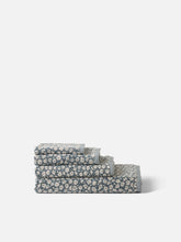 Load image into Gallery viewer, Set of three folded towels with a floral pattern on a white background