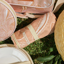 Load image into Gallery viewer, Close-up of tan floral sand-free towel and other outdoor accessories in the range laid flat on grass.